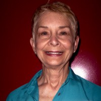 Magnolia Harbison Smiling older woman with a gray-blonde pixie cut
